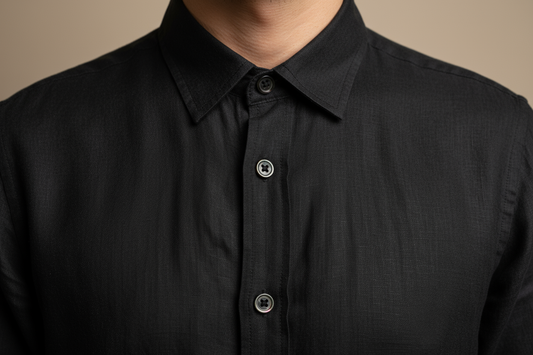 Black linen shirt collar and button detail close-up