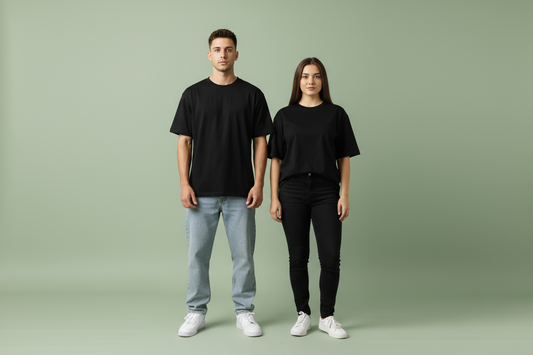 Unisex black oversized drop shoulder t-shirt on male and female models