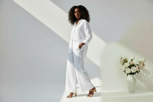 Model in clean white linen with hands in pockets